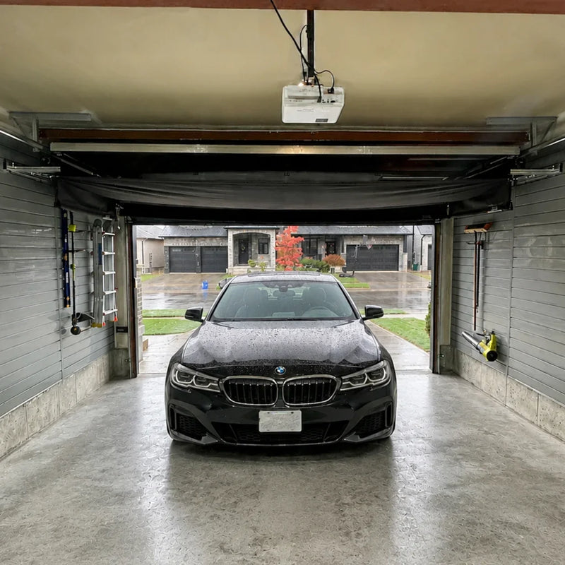 Car parked under a rolled-up Vanish 16