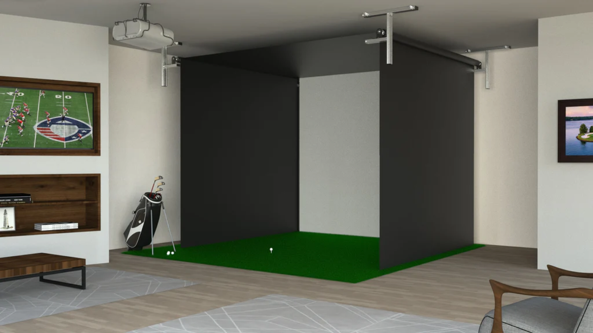 Indoor golf room with ceiling-mounted projector and retractable enclosure screens