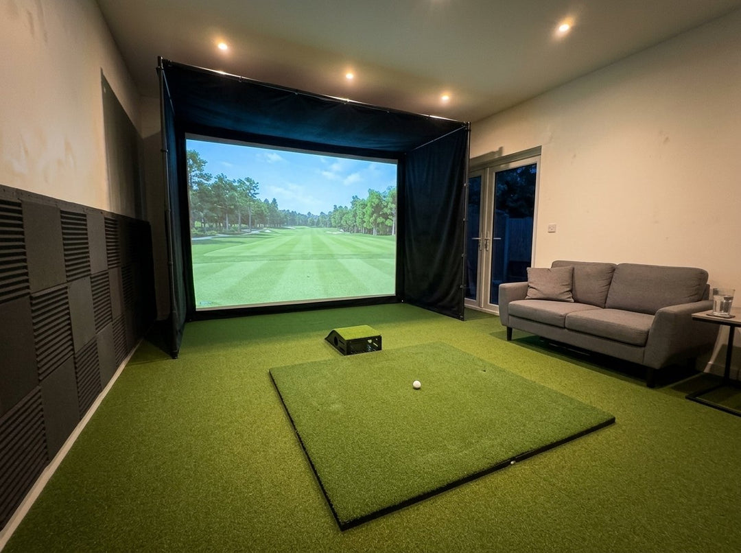 Illustration: golf simulator enclosure, hitting mat and a floor projector case in front of the mat in a UK garden room with padded wall panels, evening light
