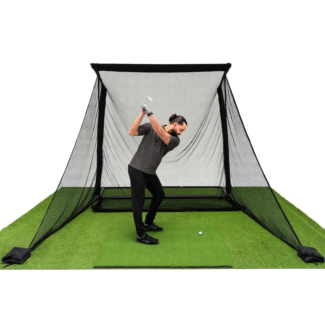 Golfer hitting a full swing into a SimSpace Deluxe Wide golf practice net in a UK garden