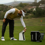 Golfer using the Garmin Approach R50 on the driving range