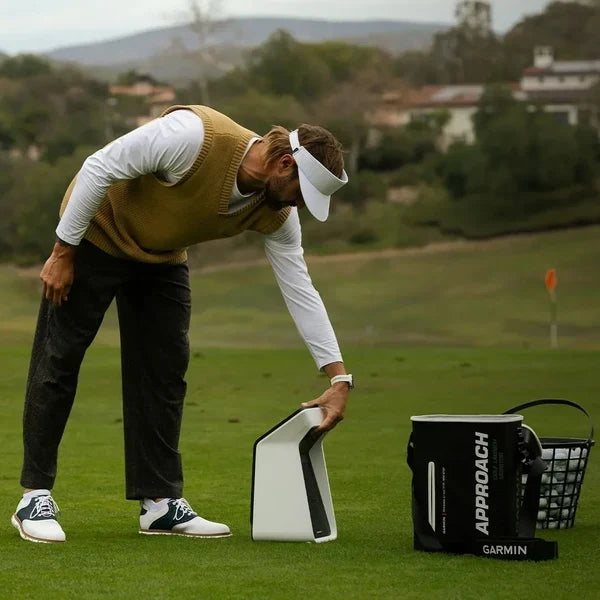 Golfer using the Garmin Approach R50 on the driving range