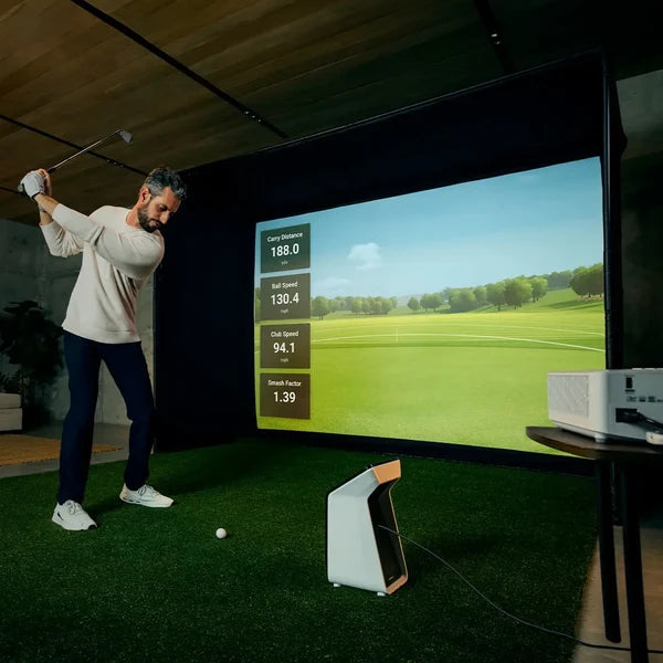 Garmin R50 simulator in a SimSpace enclosure — course play and shot data on the impact screen