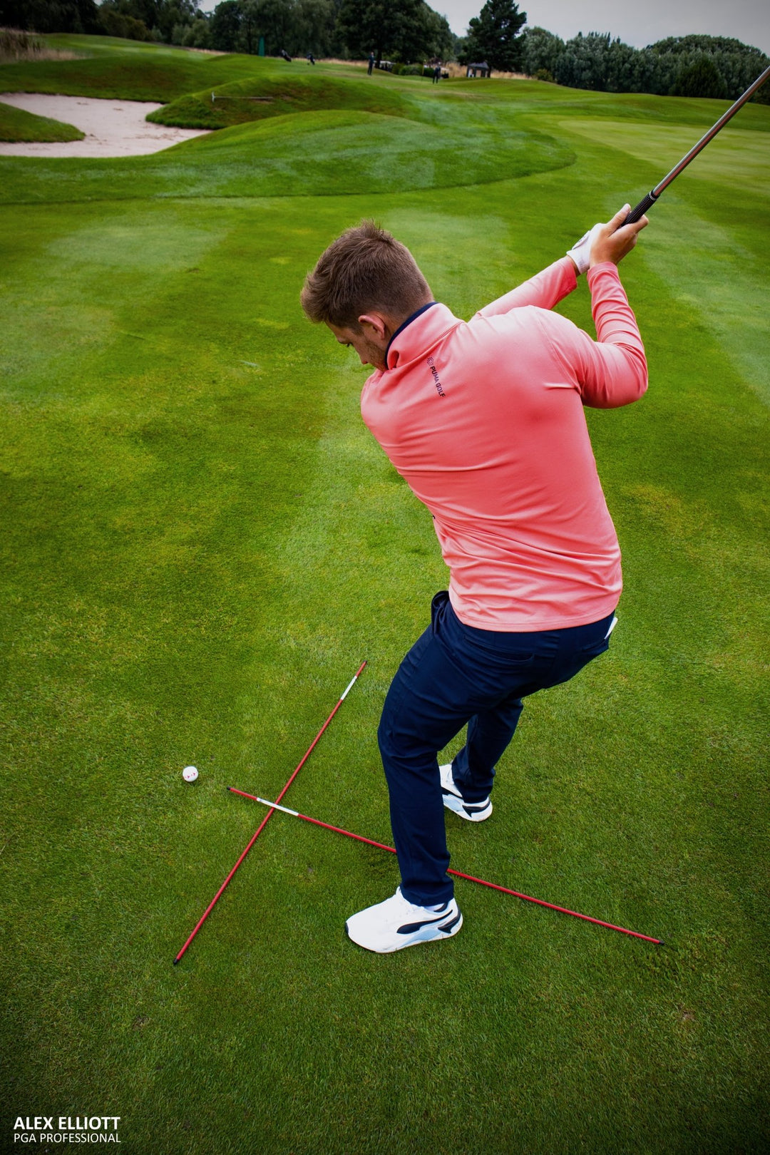 Golf practice net and mat setup featuring PGA TOUR Pro Training Sticks