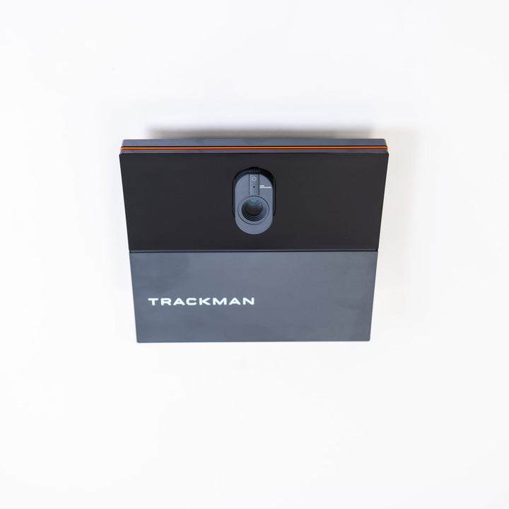 Trackman iO ceiling-mounted launch monitor in a simulator bay